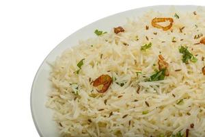 Cumin rice on white photo