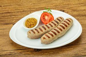 Grilled natural pork sausages with sauce photo