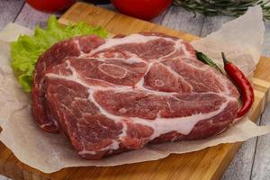 Raw pork neck steak photo