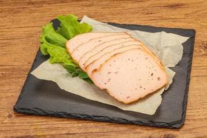 Boiled pork sausage over board photo