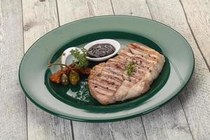 Grilled pork steak with pepper sauce photo