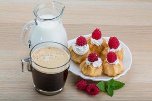 Profiterole with raspberry photo