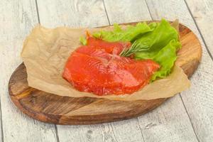 Sliced salmon fillet served rosemary photo