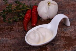 Mayonnaise sauce in the white bowl served thyme and garlic photo