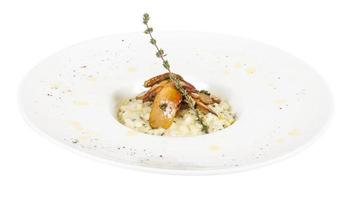 photo of delicious risotto dish with herbs and mushrooms on white background