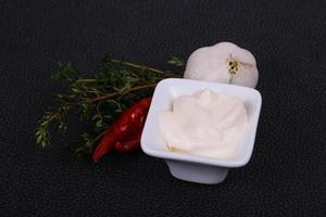 Mayonnaise sauce in the white bowl served thyme and garlic photo