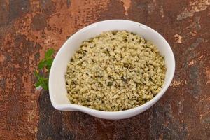 Peeled hemp seeds in the bowl photo