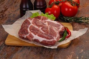 Raw pork neck steak photo
