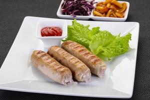 Grilled sausages served mushrooms and cabbage photo