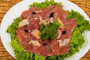 Beef carpaccio with parmesan cheese photo