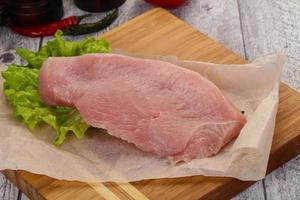 Raw Turkey steak served rosemary photo