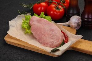 Raw Turkey steak served rosemary photo