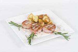 Grilled steak wrapped in bacon, with grilled vegetables, mashed potatoes photo
