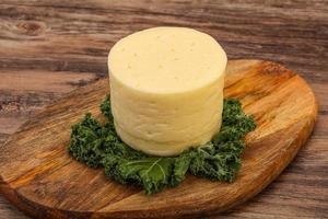Yellow round dairy soft cheese photo