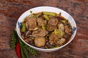 Thai style soup with meat and mushrooms photo