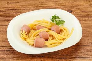 Kids pasta spaghetti with sausages photo