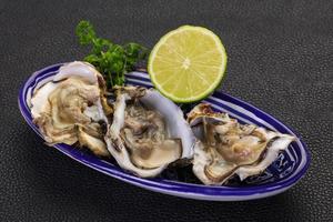 Oysters with lime and parsley photo