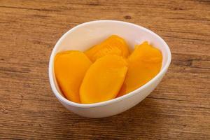 Sweet mango slices in syrop photo