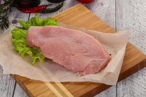 Raw Turkey steak served rosemary photo