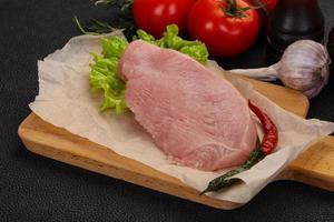 Raw Turkey steak served rosemary photo