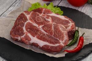 Raw pork neck steak photo