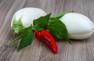 Ripe white eggplant and red hot pepper photo