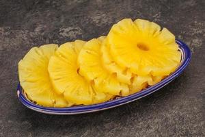 Marinated pineapple rings in the bowl photo