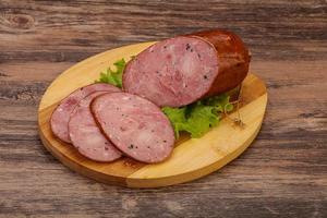 Smoked ham sausage with spices photo