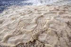 Footprints of soles in the sand photo