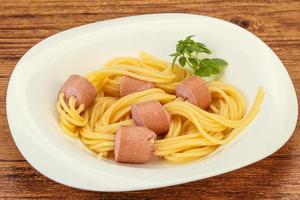 Kids pasta spaghetti with sausages photo