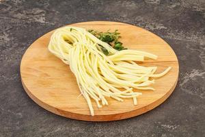 Chechil spaghetti cheese over board photo