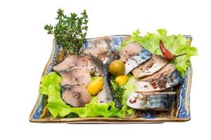 Mackerel fish, sliced on a plate with lettuce photo