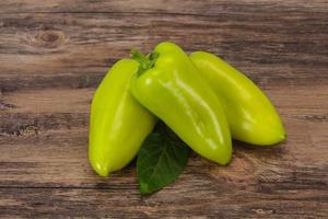 Green bell pepper over wooden background photo