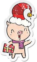 distressed sticker of a happy cartoon pig with xmas present vector