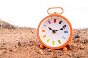 Classic Analog Clock In The Sand photo