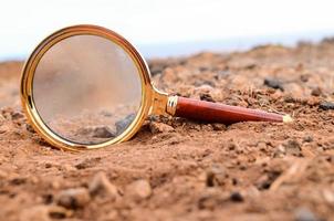 Magnifying Glass Abandoned On The Desert photo