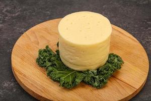 Yellow round dairy soft cheese photo