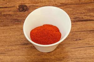 Dry paprika powder in the bowl photo