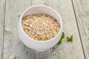 Raw oats in the bowl photo