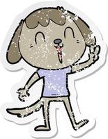 distressed sticker of a happy cartoon dog giving peace sign