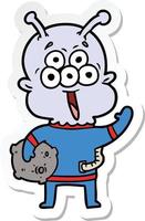 sticker of a happy cartoon alien with moon rock vector