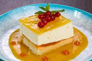 Traditional Cheesecake with orange sauce photo