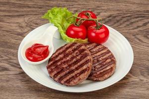 Grilled burger cutlet with sauce photo