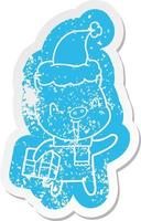 happy cartoon distressed sticker of a pig with xmas present wearing santa hat vector