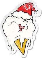 distressed sticker cartoon of a melting ice cream wearing santa hat vector