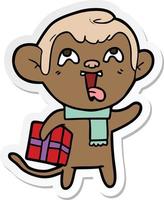 sticker of a crazy cartoon monkey with christmas present vector