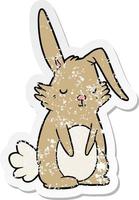 distressed sticker of a cartoon sleepy rabbit vector