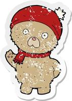 retro distressed sticker of a cartoon teddy bear in winter hat and scarf vector