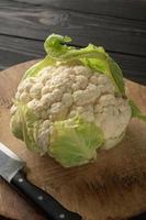 Raw, fresh organic cauliflower on a wooden background. Healthy eating, low carb diet concept photo