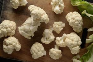 Raw, fresh organic cauliflower on a wooden background. Healthy eating, low carb diet concept photo